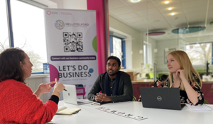 Three business people having a discussion in a conference room at the Wakes in Oakengates.