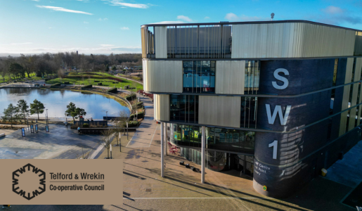 An aerial photo of Telford & Wrekin Council's SW1 building in the sunshine with a lake behind