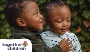 Two male toddlers hug