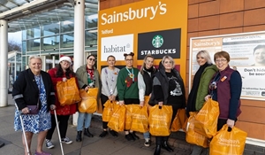 A group of people collecting food hampers from Sainsbury's