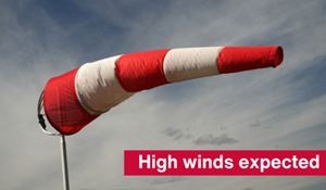 A photo of a wind sock and text reading high winds expected