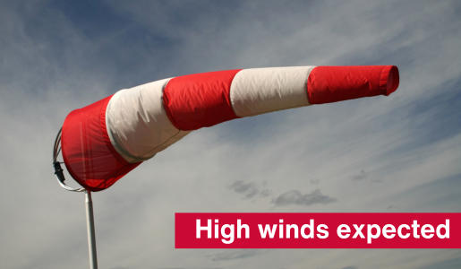 A photo of a wind sock and text reading high winds expected