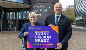 Councillor Shirley Reynolds with Councillor Lee Carter holding a young person grant graphic in front of Southwater