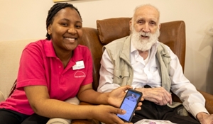 Rue and Mike sat showing Digital Care Records