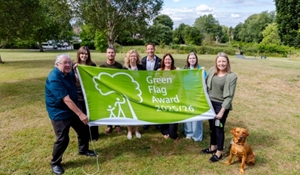 Councillor Carolyn Healy, Telford & Wrekin Council Cabinet Member for Neighbourhoods, Planning and Sustainability, far right, and Councillor Peter Scott, Ward Member for Newport West, far left, with staff celebrating the Green Flag award for Victoria Park.