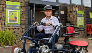 Councillor Ollie Vickers outside Telford Bike Hub on an adaptive bike