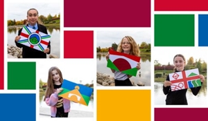 Flag competition finalists, each holding the flag design they inspired