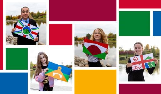 Flag competition finalists, each holding the flag design they inspired