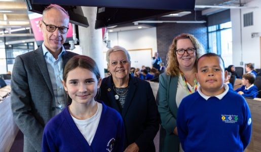 A group photo of schoolchildren and adults who took part in the school debate in the Council Chamber