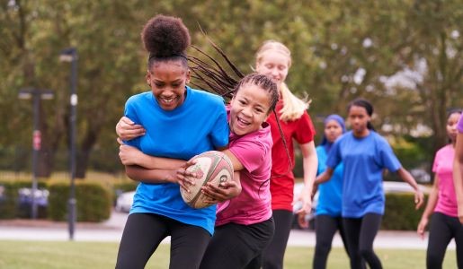 Girls play rugby outside