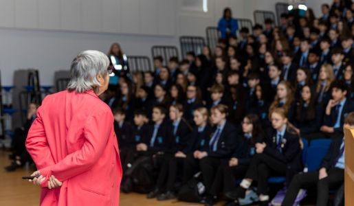Lesley Urbach speaks to assembly hall of pupils