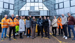Members of Council staff standing in front of Darby House and smiling
