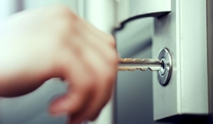 HMO consultation - a close up view of a person placing a key in a door lock