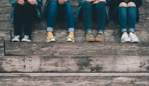 Four teenagers sitting on steps