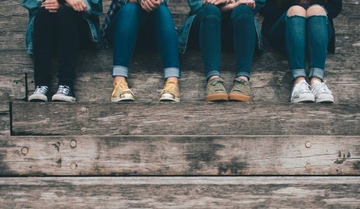 Four teenagers sitting on steps