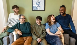 Group of people sitting on a sofa in the Denmark House show home