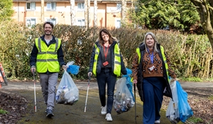 Three volunteer litter-pickers collecting litter in Telford Town Park