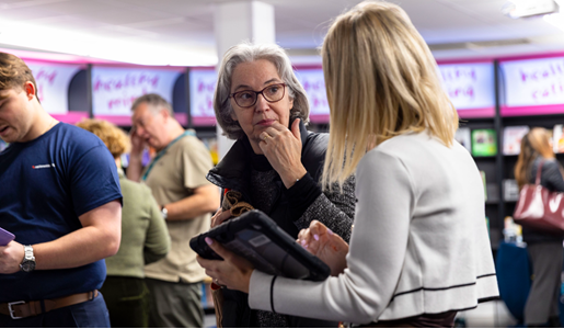 Older woman speaking to other woman at Live Well Hub