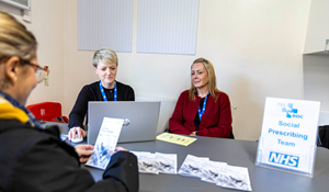Teldoc healthcare staff at a Live Well Community Hub helping a resident
